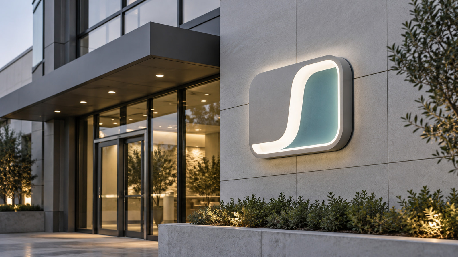 Professional illuminated sign integrated into a clear commercial facade