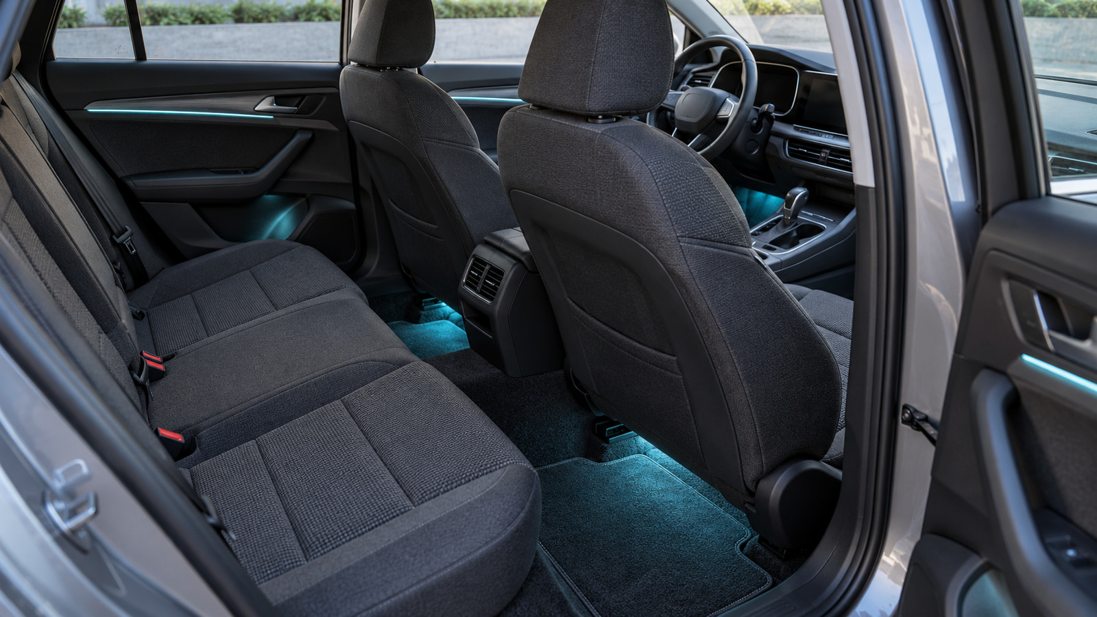 Car interior with cyan footwell and door-trim lighting