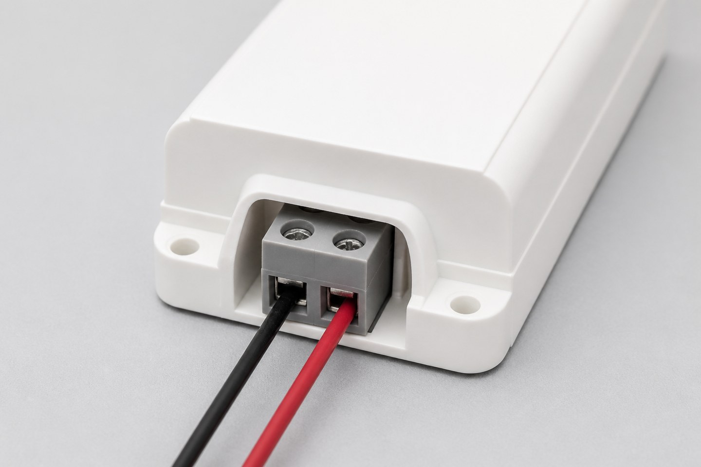 Close-up of an LED driver output terminal block with two wire leads connected.