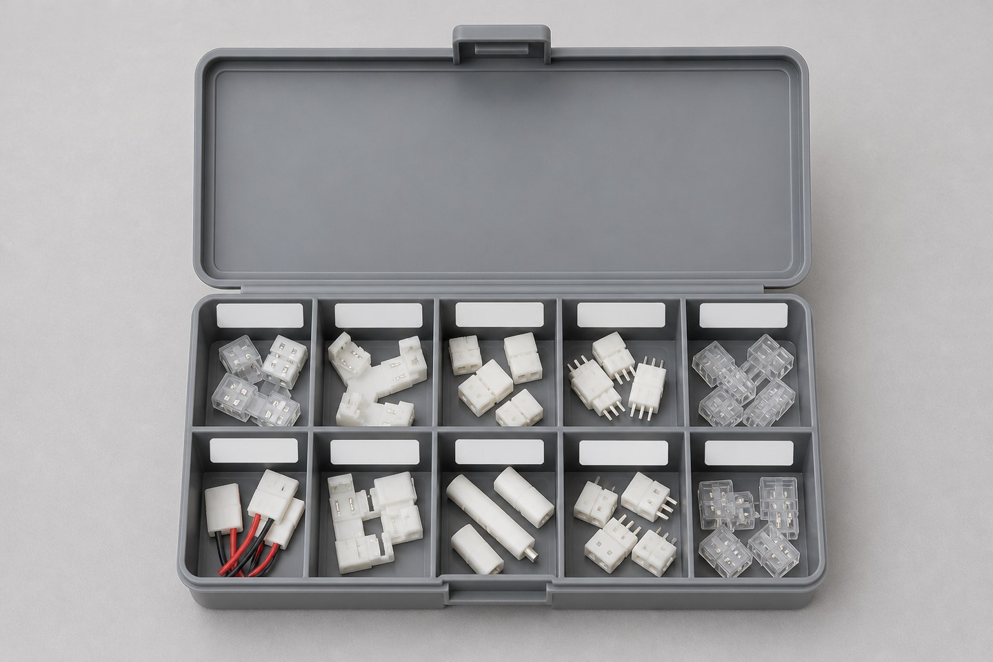 A small organizer tray with compartments holding labeled LED connector samples.