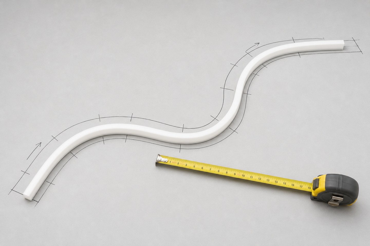 An unlit length of neon flex laid along a marked path next to a tape measure.