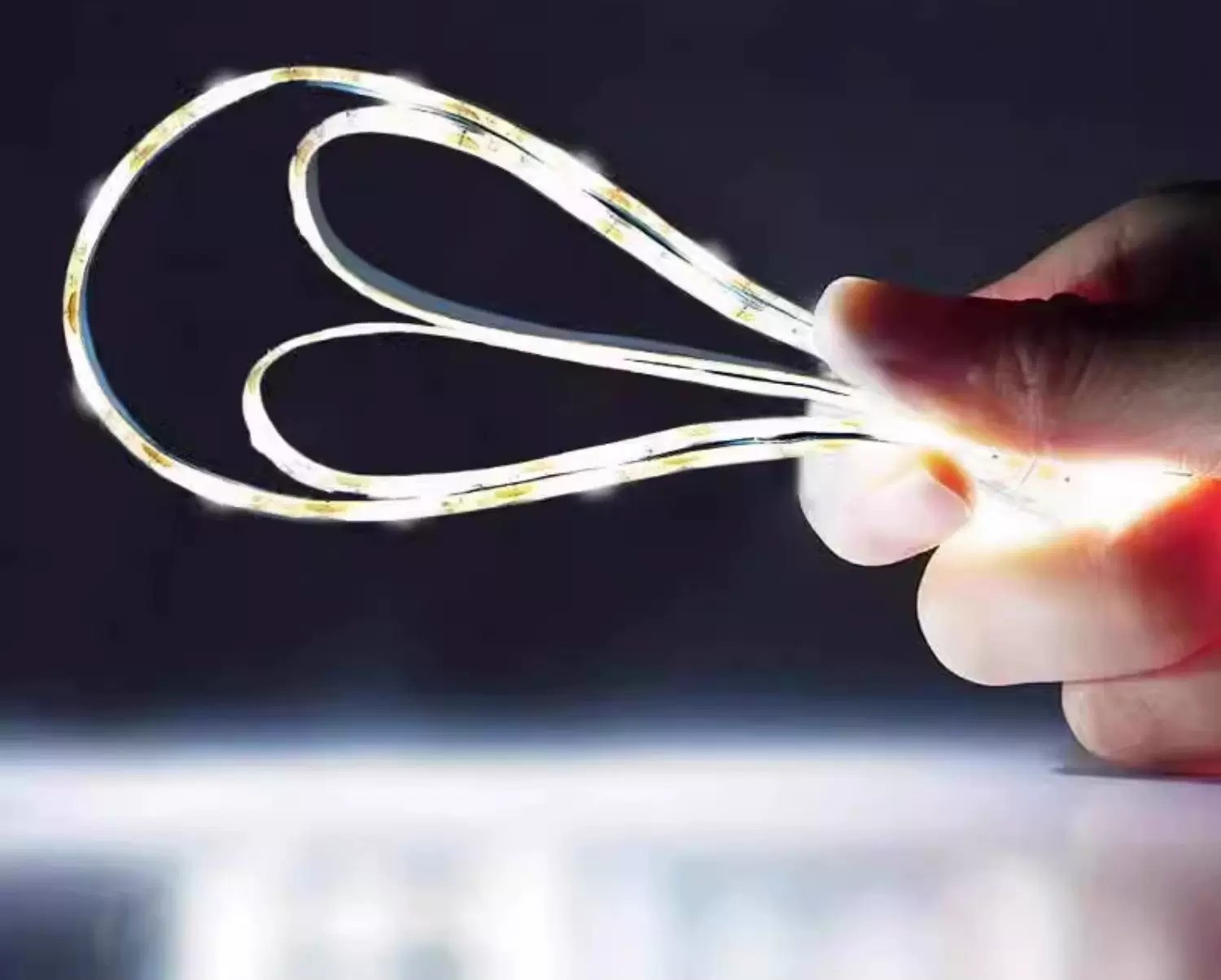 Hand-held white LED strip showing flexible loops