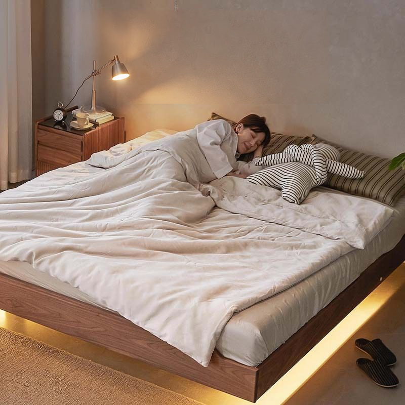 Warm-white strip illuminating the lower edge of a bed.
