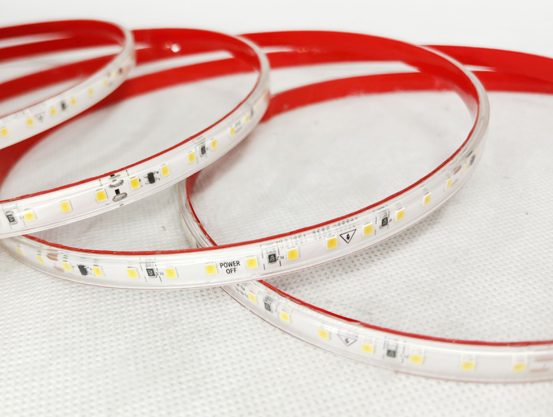 Expanded single-row LED strip with clear covering and red adhesive backing.