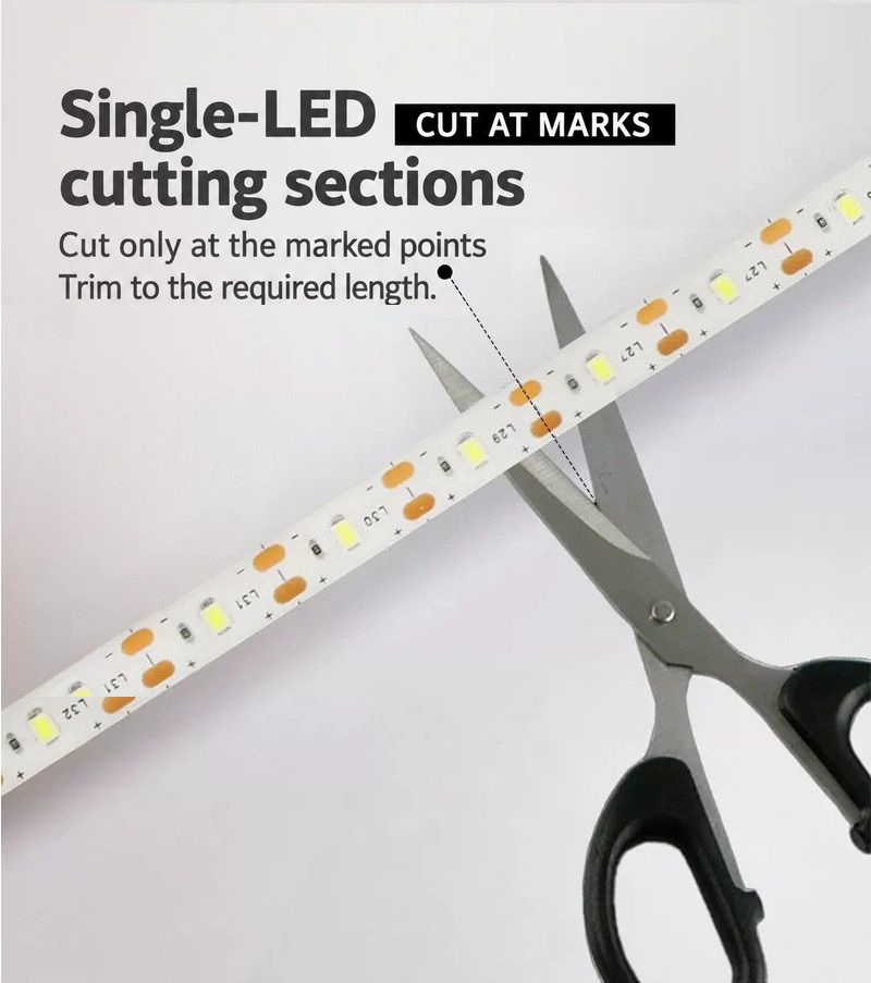 Scissors aligned with copper cut pads on the LED strip