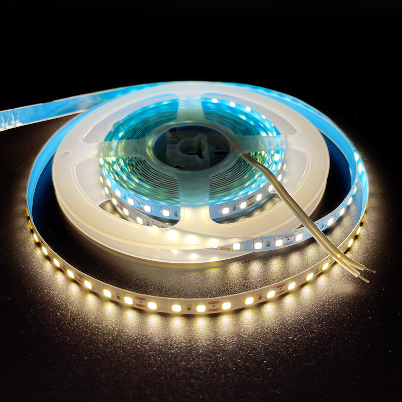 Neutral-white LED strip reel with connection leads.