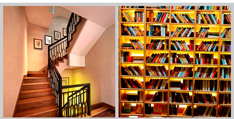 Warm-white lighting along stairs and library shelves.