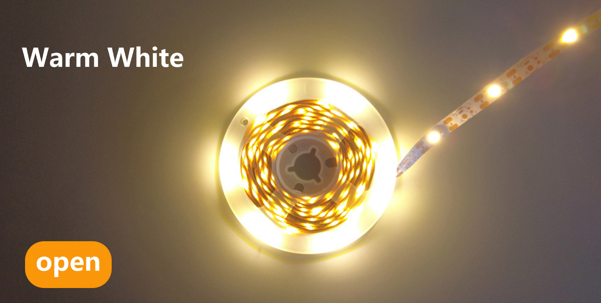 Warm-white LED strip illuminated on a reel.