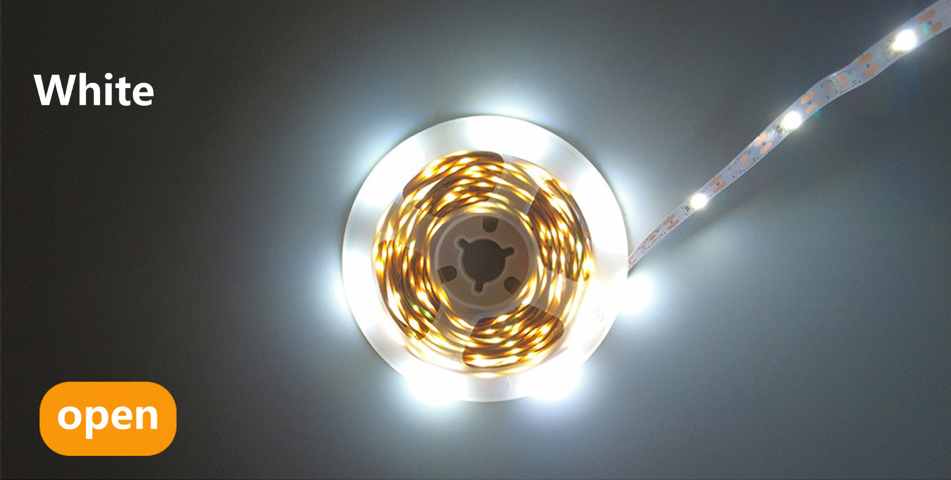 Cool-white LED strip illuminated on a reel.