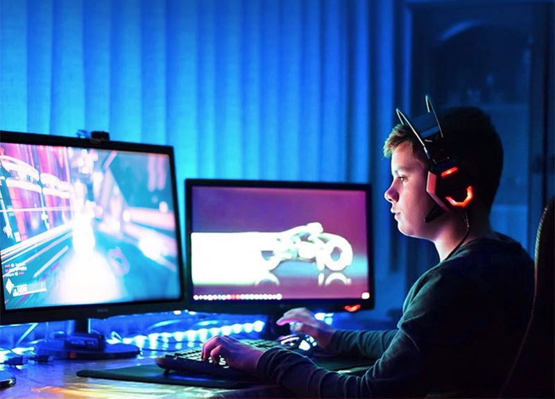 RGB strip lighting around a gaming desk.