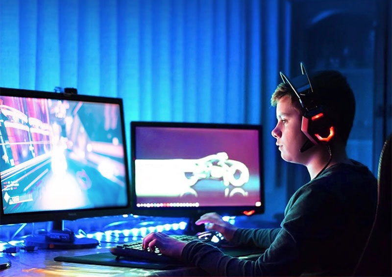 Blue strip lighting around a gaming desk.