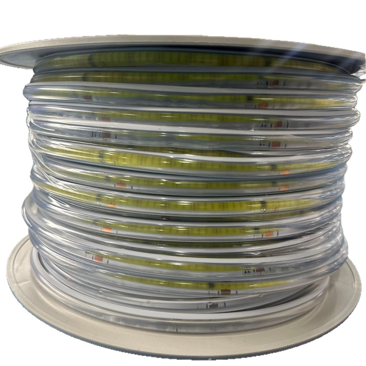 Reel of coated COB strip with visible transparent sleeve.