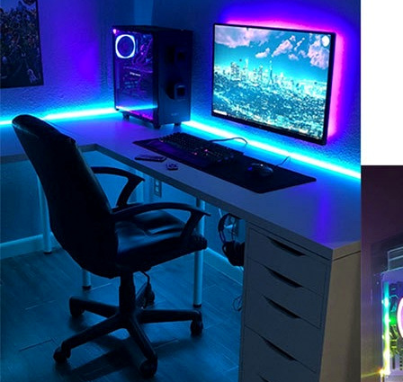 RGB strip lighting around a gaming desk and monitor