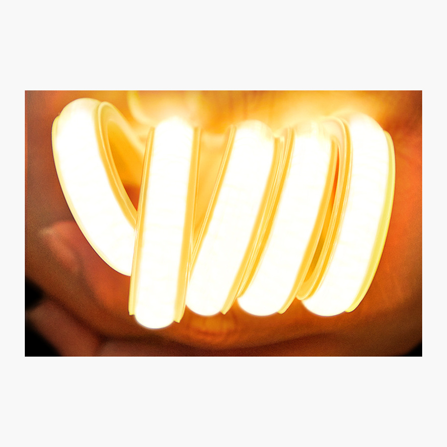 Lit flexible COB strip bent around a hand