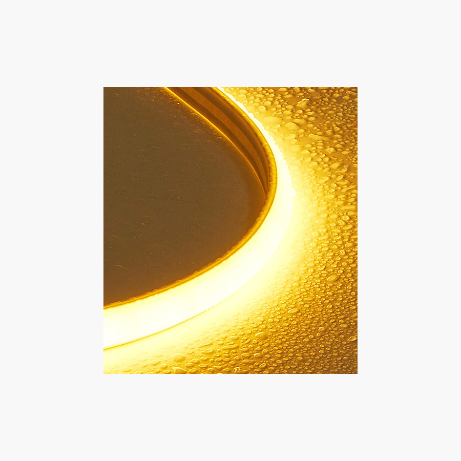 Close-up of the lit sealed COB strip body against a textured surface
