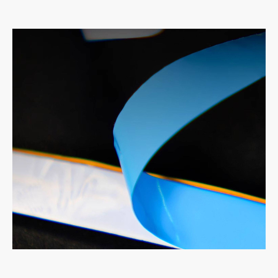 COB strip lifted to show the blue adhesive backing