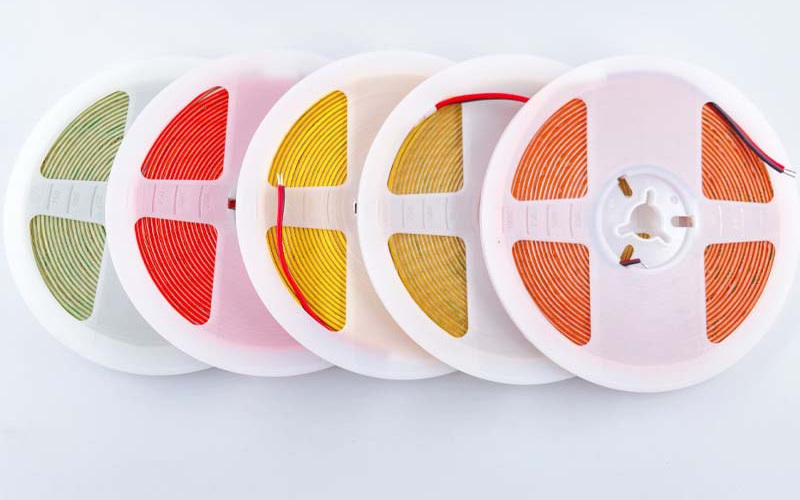 Overlapping reels of ultra-narrow colored COB strip