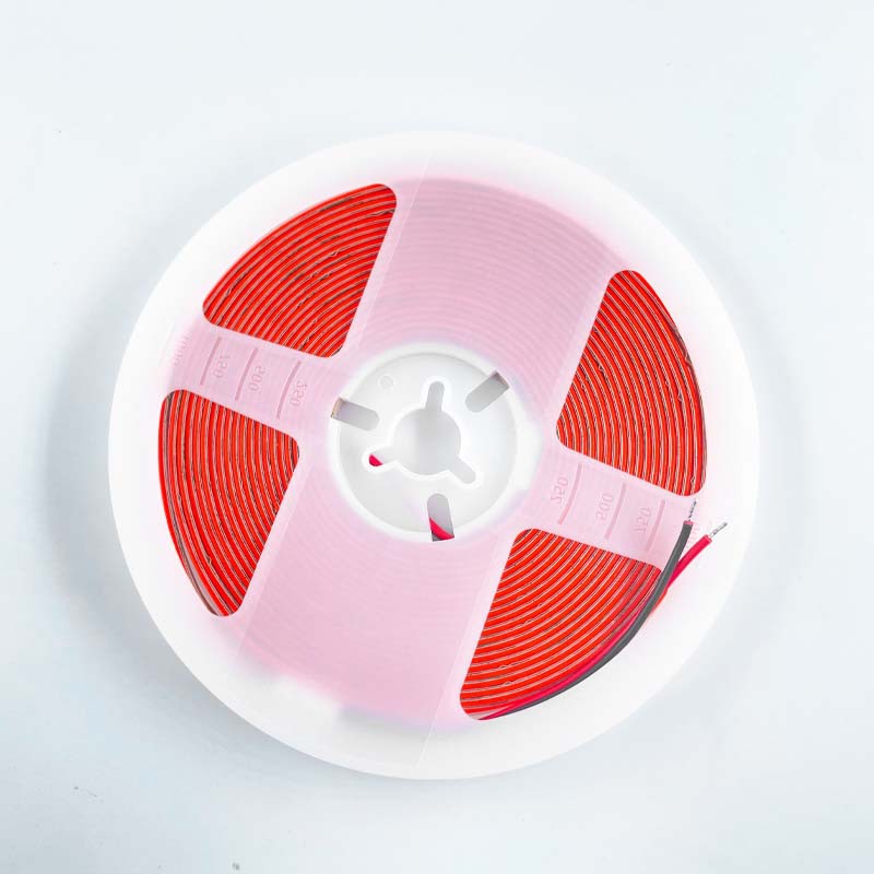 Red COB LED strip arranged on a white reel