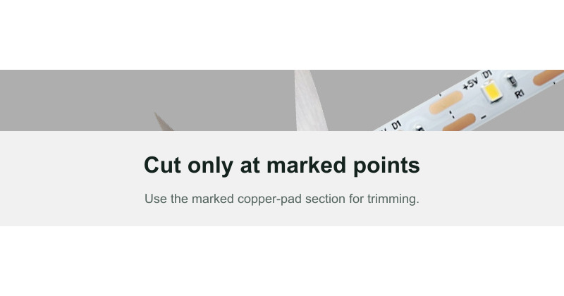 Scissors aligned with a marked LED strip cut point